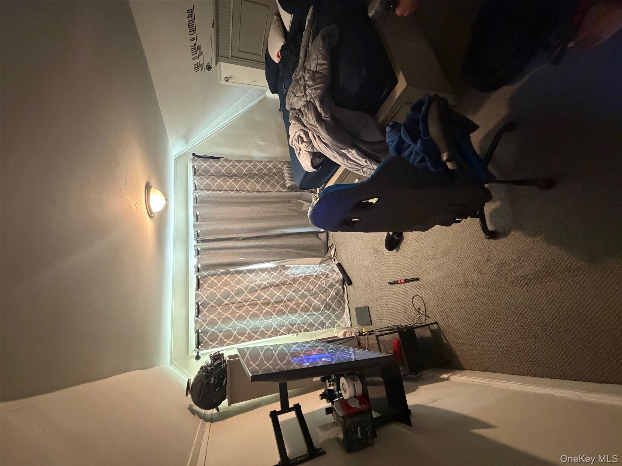 686 East 239th Street Bronx, NY 10470 - Photo 22 of 30 a room with furniture and a window