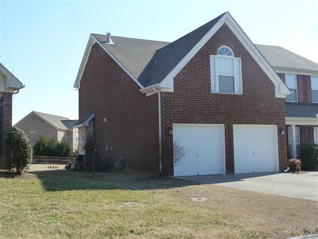 2002 Silverton Circle Spring Hill, TN 37174 - Photo 2 of 17 a front view of a house with a yard and garage