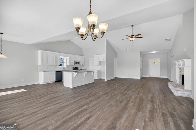 a view of a kitchen with a sink and chandelier