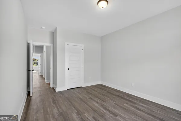 a view of a room with wooden floor