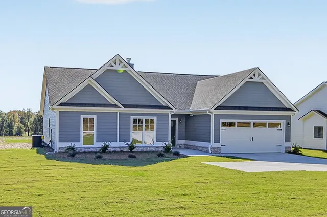 a view of a house with pool and chairs