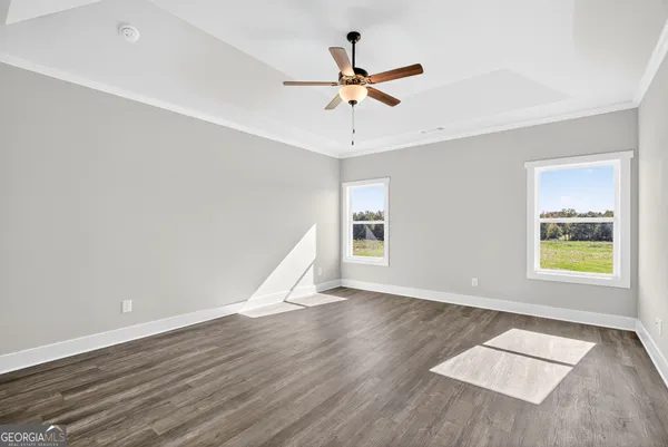 wooden floor in an empty room with a window