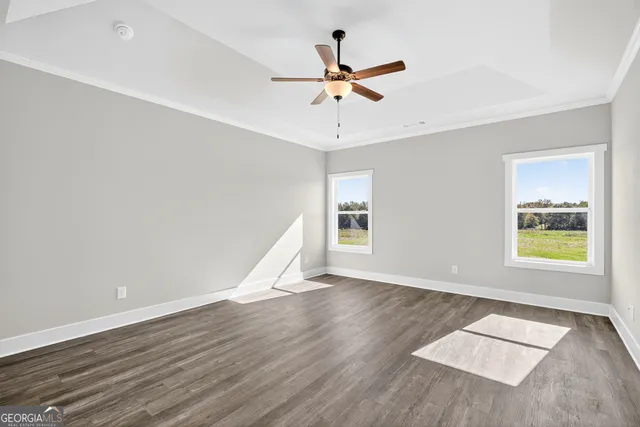 wooden floor in an empty room with a window