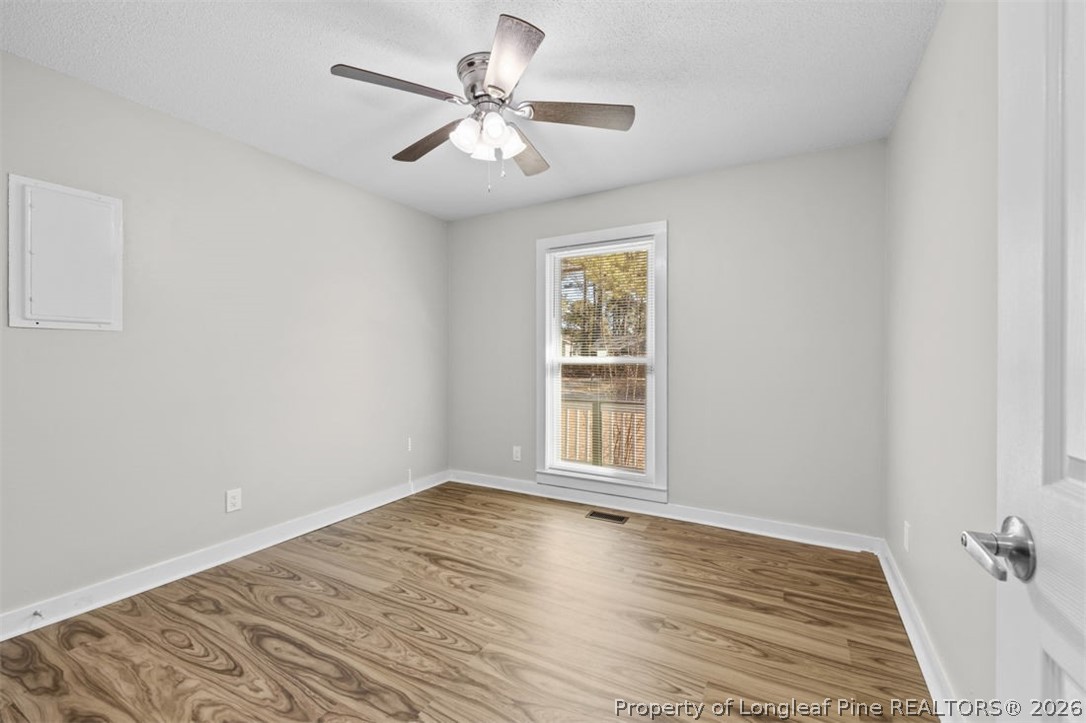 3305 Hunting Bay Drive Spring Lake, NC 28390 - Photo 15 of 27 wooden floor in an empty room with a window