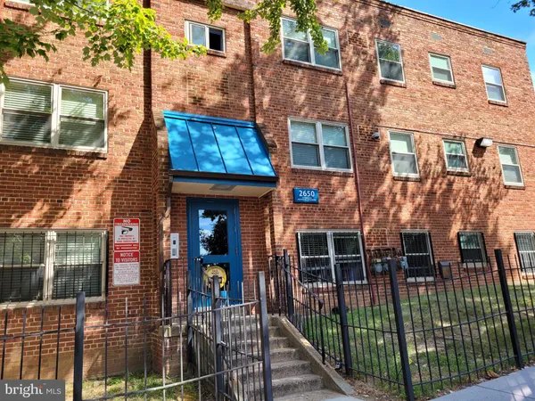 a view of a brick building with many windows
