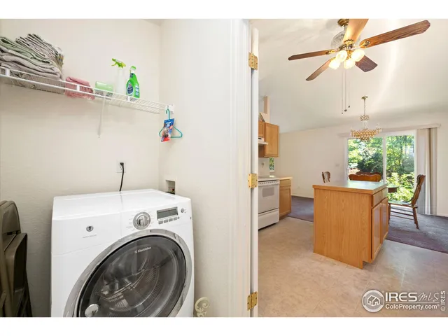 a view of kitchen with furniture and a fan