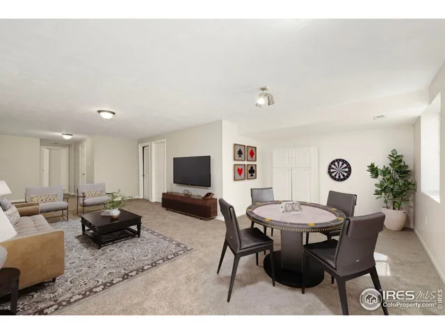 a living room with furniture a table and a potted plant