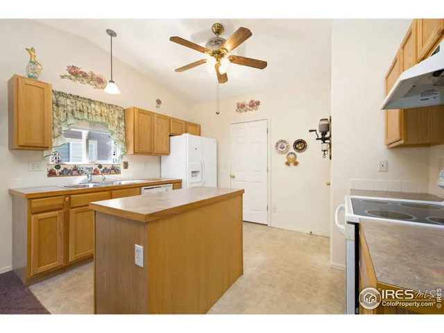 a kitchen with cabinets and window