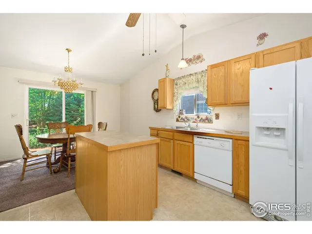 a kitchen with a refrigerator and white cabinets