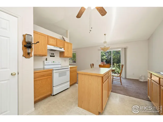 a kitchen that has a lot of cabinets in it and wooden floors