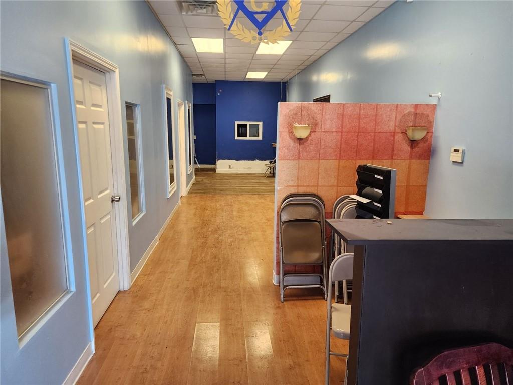 6958 Main Street Lithonia, GA 30058 - Photo 7 of 55 a view of a hallway with a couch and wooden floor