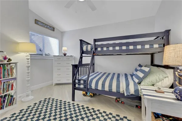 a bedroom with furniture and a book shelf