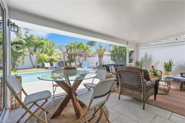 a view of a dining room with furniture large windows and wooden floor