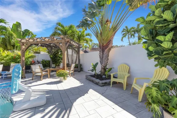 a view of a backyard with plants and a patio