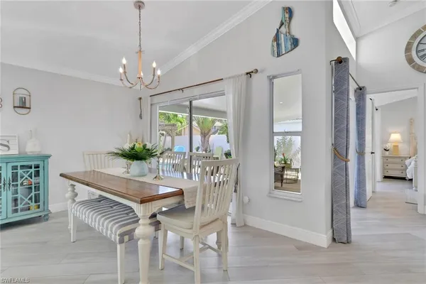 a view of a dining room with furniture and chandelier