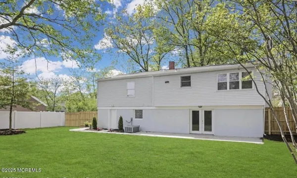 a backyard of a house with table and chairs