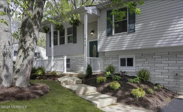 a backyard of a house with a garden and outdoor seating
