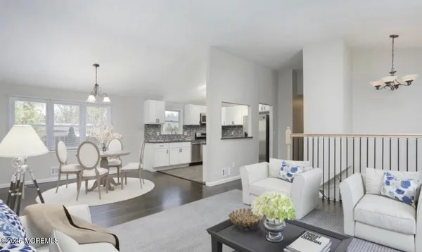 a living room with furniture and a chandelier