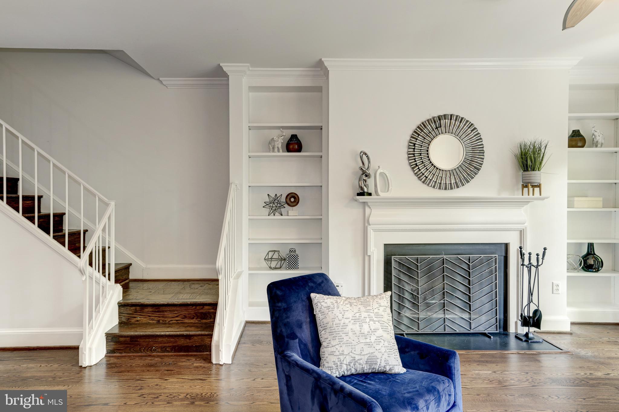 3205 Sutton Place Northwest, Unit D Washington, DC 20016 - Photo 3 of 25 Living area fireplace and staircase to upper level