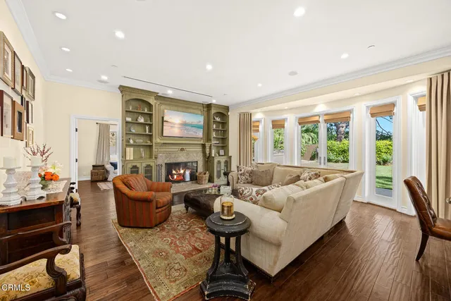 a living room with furniture and a floor to ceiling window