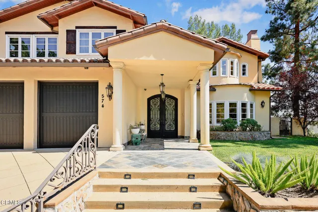 a front view of a house with garden