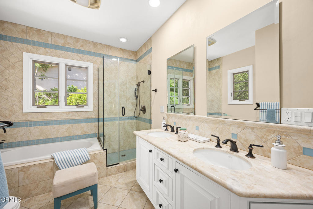 574 Camillo Road Sierra Madre, CA 91024 - Photo 46 of 72 a bathroom with double vanity sinks a large mirror and a bathtub