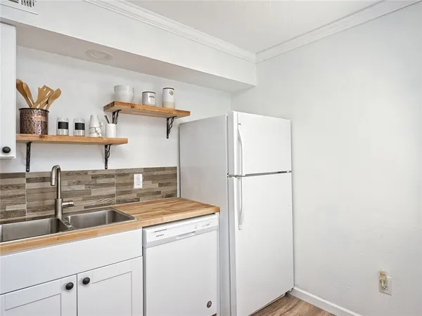 a kitchen with a refrigerator and cabinets