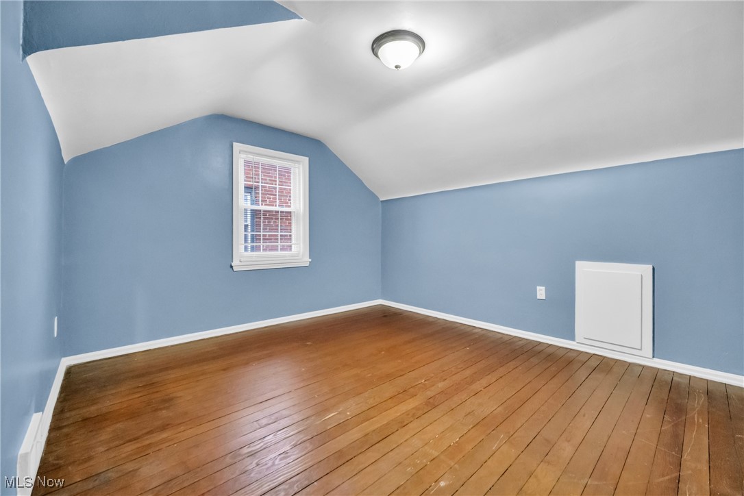 1605 Laclede Road Cleveland, OH 44121 - Photo 12 of 40 Bonus room featuring hardwood / wood-style floors, vaulted ceiling, and baseboards
