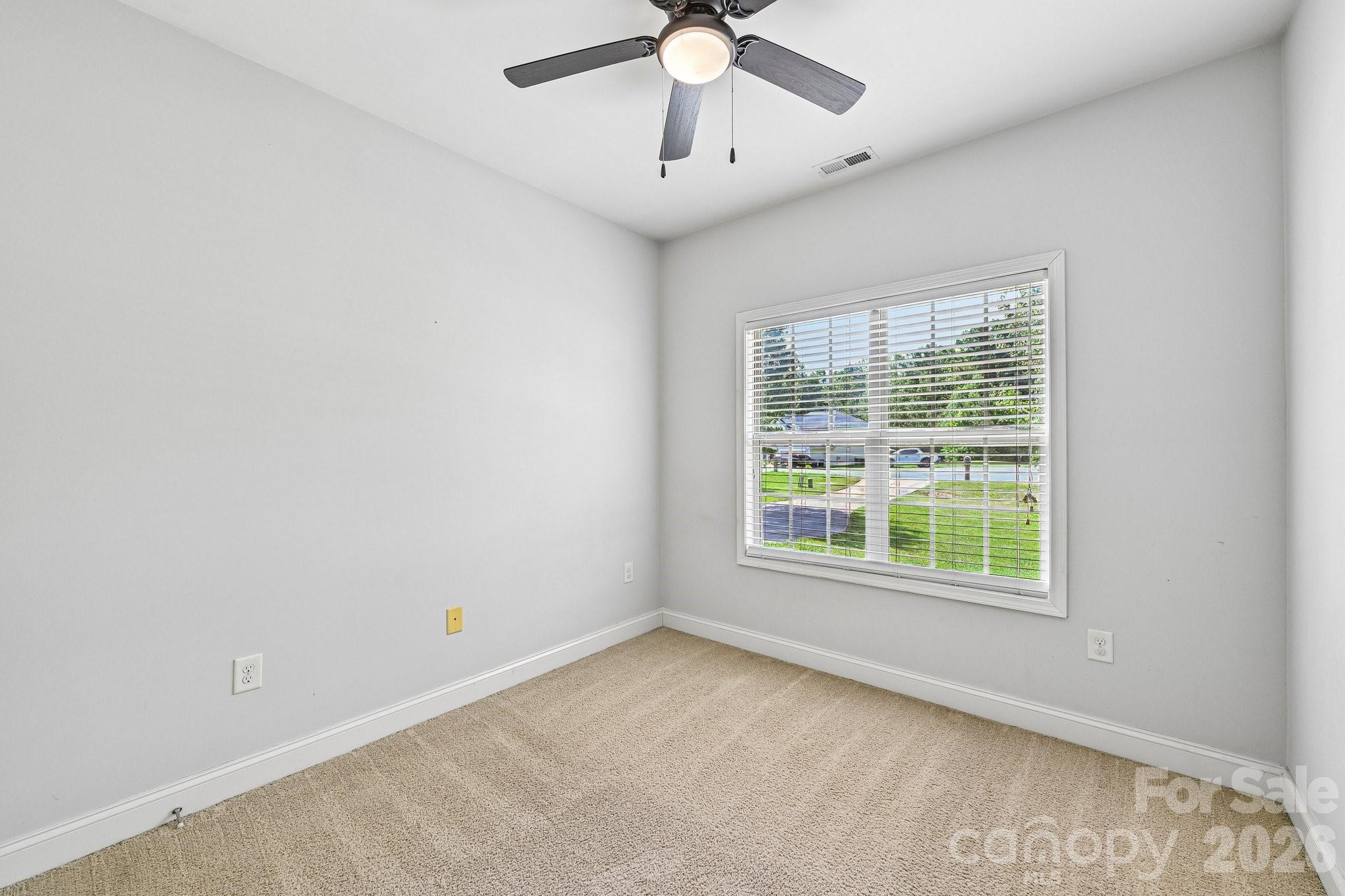 624 Hunley Street Monroe, NC 28112 - Photo 23 of 36 an empty room with a window and a fan