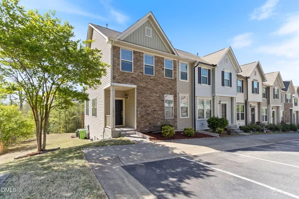 a view of a brick house with many windows