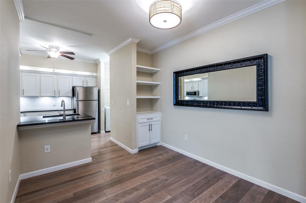 2601 Preston Road, Unit 3103 Plano, TX 75093 - Photo 10 of 30 Kitchen counter, built in cabinet, drawer & shelves in Dining area. Decorative framed mirror gives an open feel in Dining area. Decorative light in Dining area.