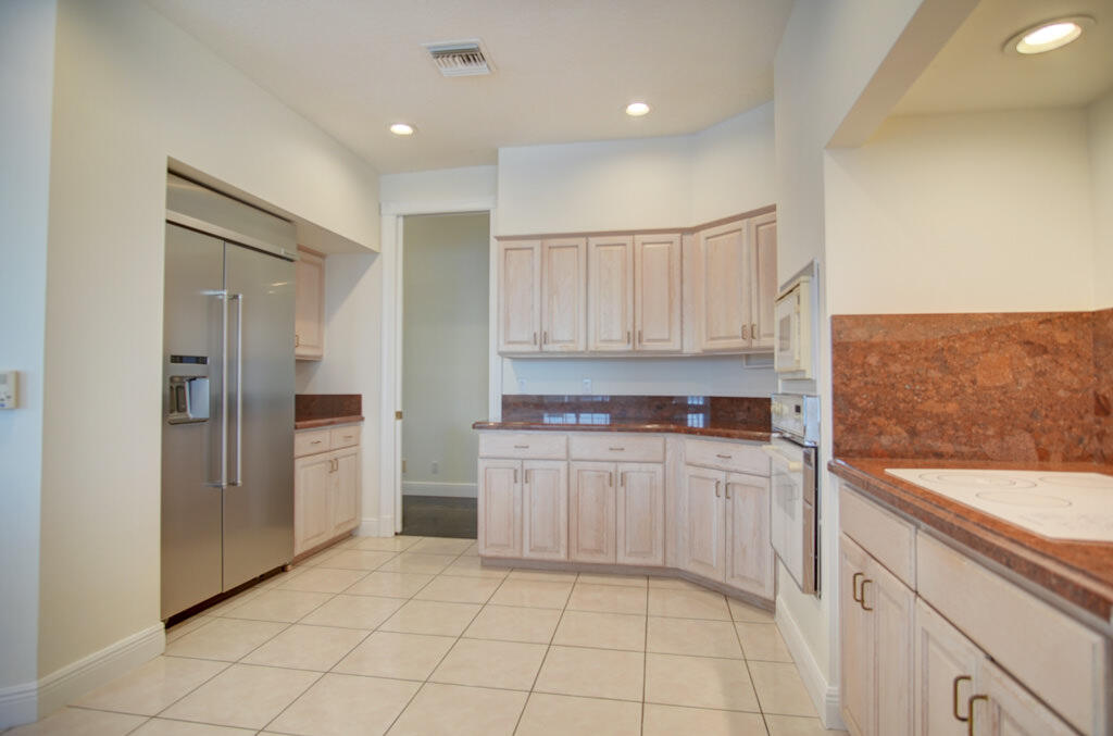 1823 Southwest 17th Street Boca Raton, FL 33486 - Photo 20 of 67 a kitchen with white cabinets and refrigerator