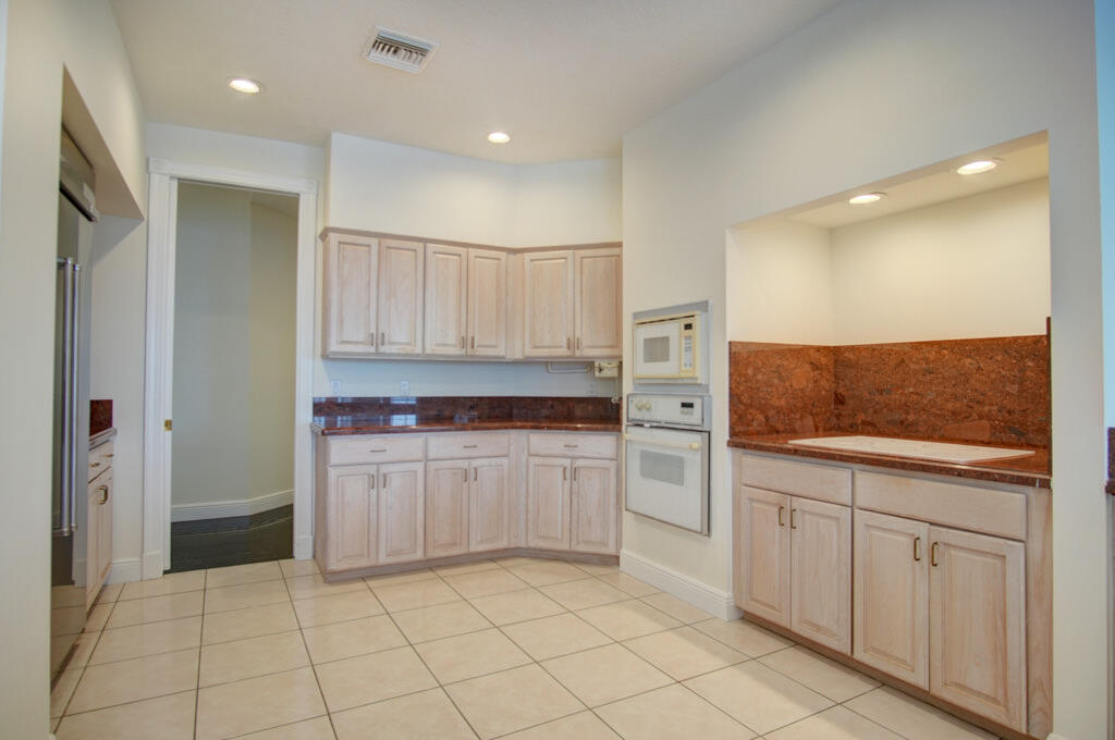 1823 Southwest 17th Street Boca Raton, FL 33486 - Photo 23 of 67 a kitchen with white cabinets