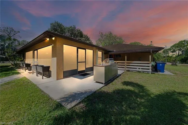 a view of a house with a backyard and a patio