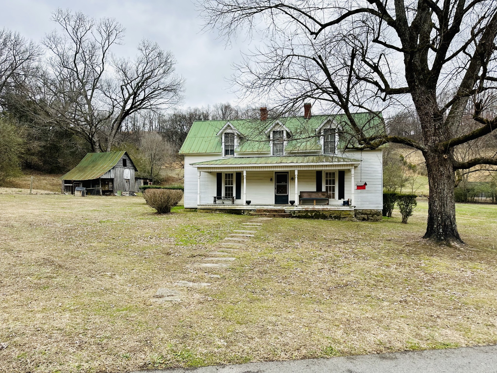 a view of house with outdoor space and sitting area