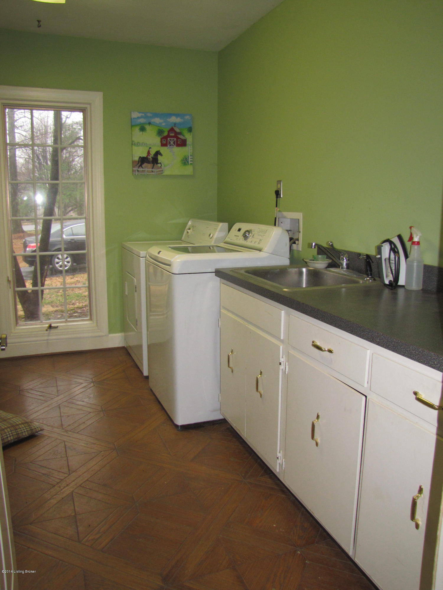 10710 Sun Ridge Road Goshen, KY 40026 - Photo 22 of 55 The Laundry Room is extremely spacious, offering a generous length of clothes hanging space; A sunny window compliments the Laundry Room – making it a bright and cheery space! There is cabinetry, counter space, and a utility sink in this Laundry Room
