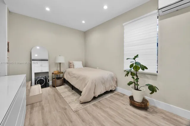 a bed room with a bed and a potted plant