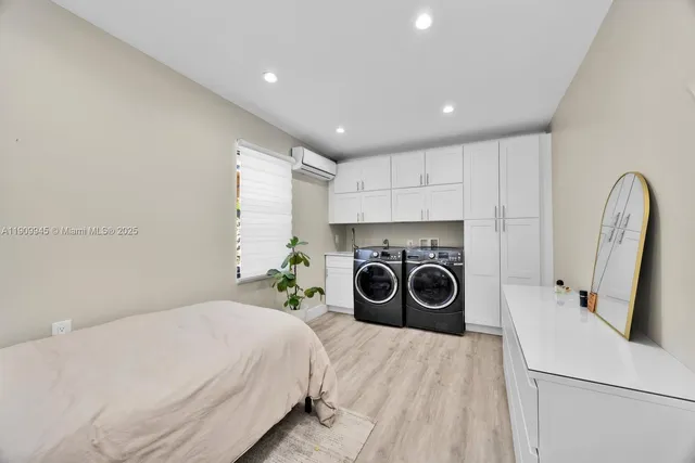 a bed room with a bed and a washing machine