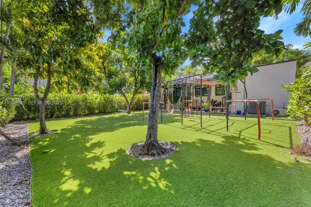 a view of a house with a backyard porch and sitting area