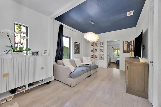 a living room with furniture and large windows