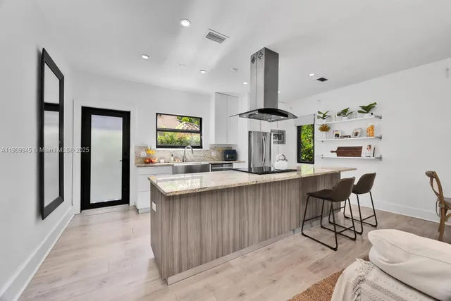 a kitchen with stainless steel appliances a sink stove and cabinets