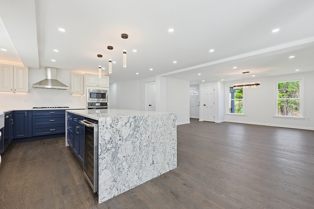 175 Pleasant Street Upton, MA 01568 - Photo 8 of 39 a large kitchen with stainless steel appliances granite countertop a large counter top a stove and a sink