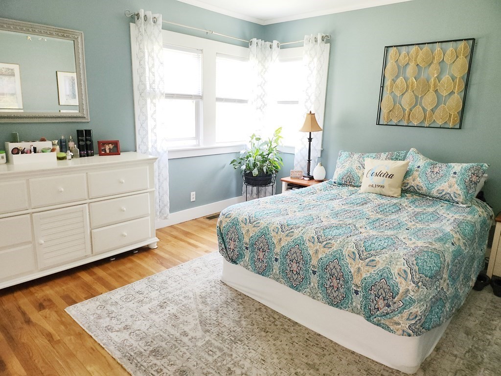 112 Marion Road Rochester, MA 02770 - Photo 11 of 18 a bedroom with a bed and wooden floor