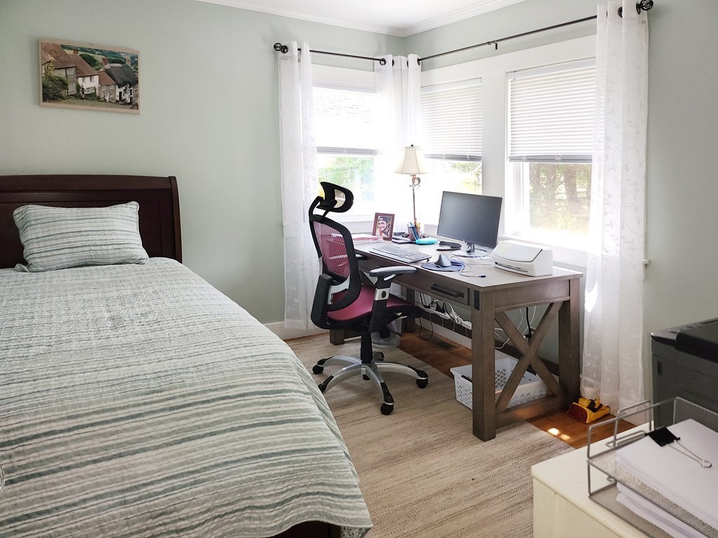 112 Marion Road Rochester, MA 02770 - Photo 14 of 18 a bedroom with a bed a desk and chair