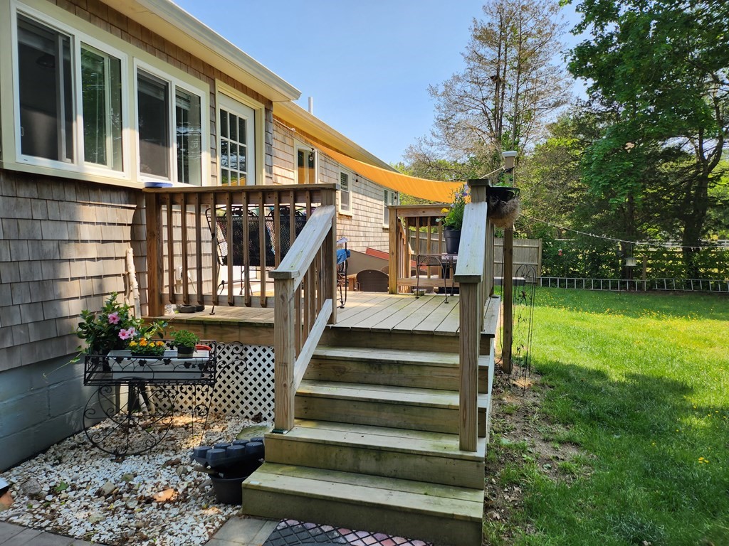 112 Marion Road Rochester, MA 02770 - Photo 17 of 18 a view of a house with backyard and sitting area