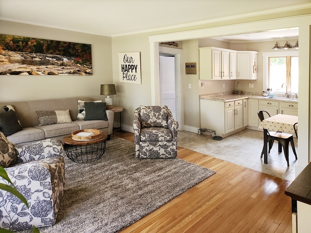 112 Marion Road Rochester, MA 02770 - Photo 3 of 18 a living room with furniture and a dining table with kitchen view