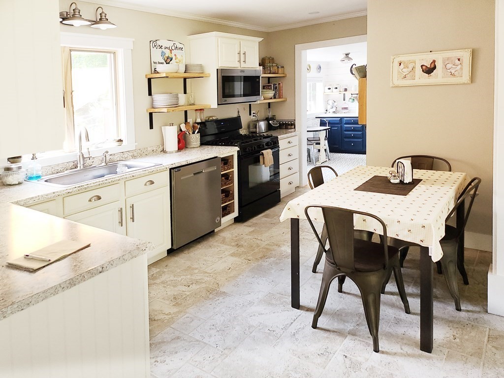 112 Marion Road Rochester, MA 02770 - Photo 5 of 18 a kitchen with a sink a stove and chairs