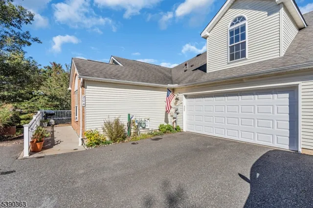 a view of a house with garage and yard