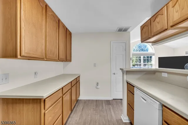 a kitchen with stainless steel appliances granite countertop a sink and a microwave