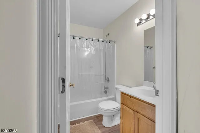 a bathroom with a shower a toilet and a sink